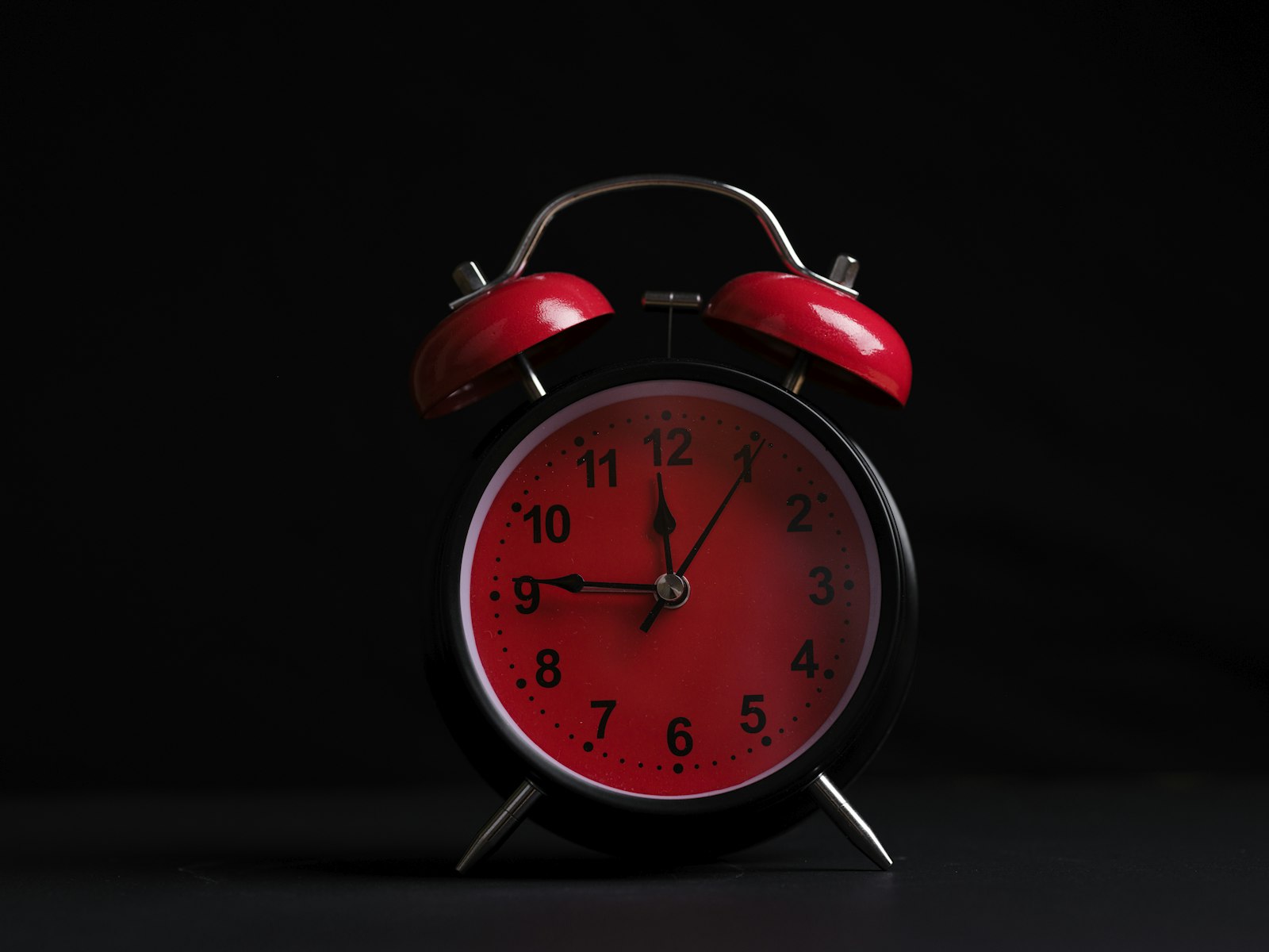 Alarm clock on a bedside table in morning light