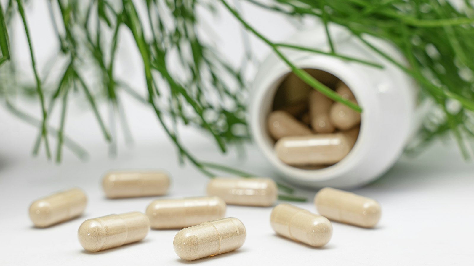 Swisse vs Blackmores comparison: berberine and saffron capsules spilling from a white supplement bottle