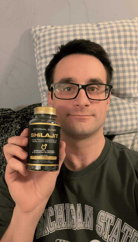 Person holding a bottle of Eternal Elixir Shilajit capsules